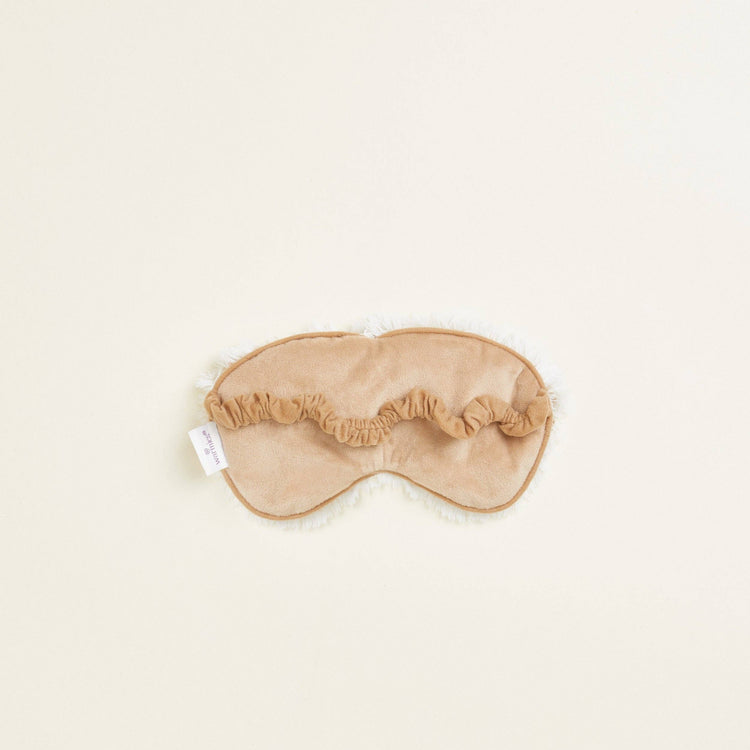 Close-up of back of Warmies reusable hot and cold eye mask scented with real French lavender.