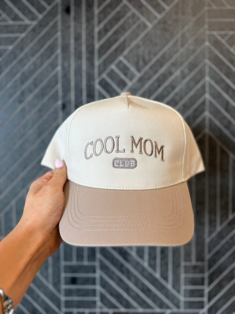 Close-up of bold Cool Mom Club embroidery on a trendy two-tone baseball hat.
