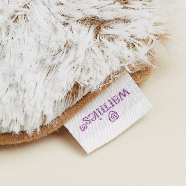 Close-up of Warmies reusable hot and cold eye mask scented with real French lavender.