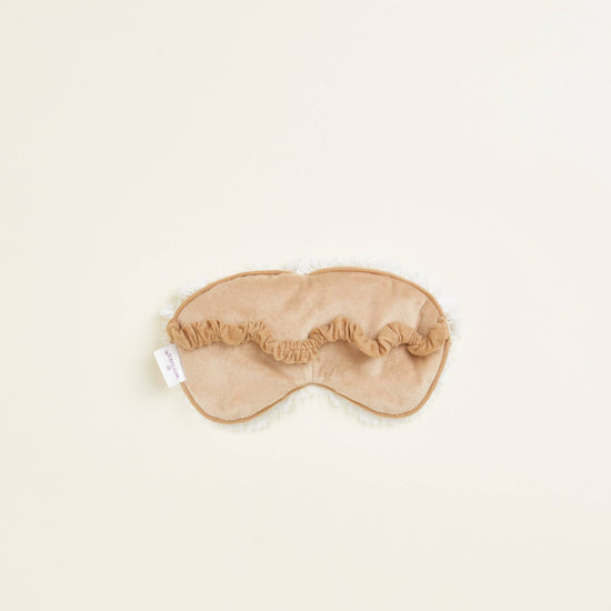 Close-up of back of Warmies reusable hot and cold eye mask scented with real French lavender.